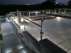 Top_patio_at_night_with_installed_water_feature,_walls_and_glass_balistrade